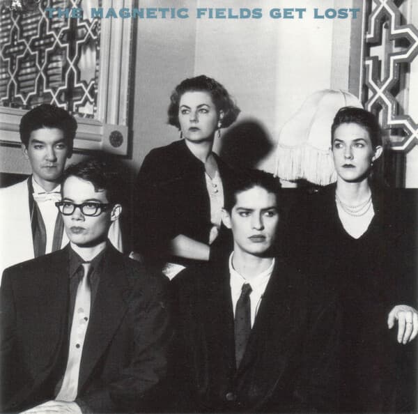 A picture of the album cover for "Get Lost", performed by the Magnetic Fields. The image is a black and white photo of 3 men and 2 women looking off camera.